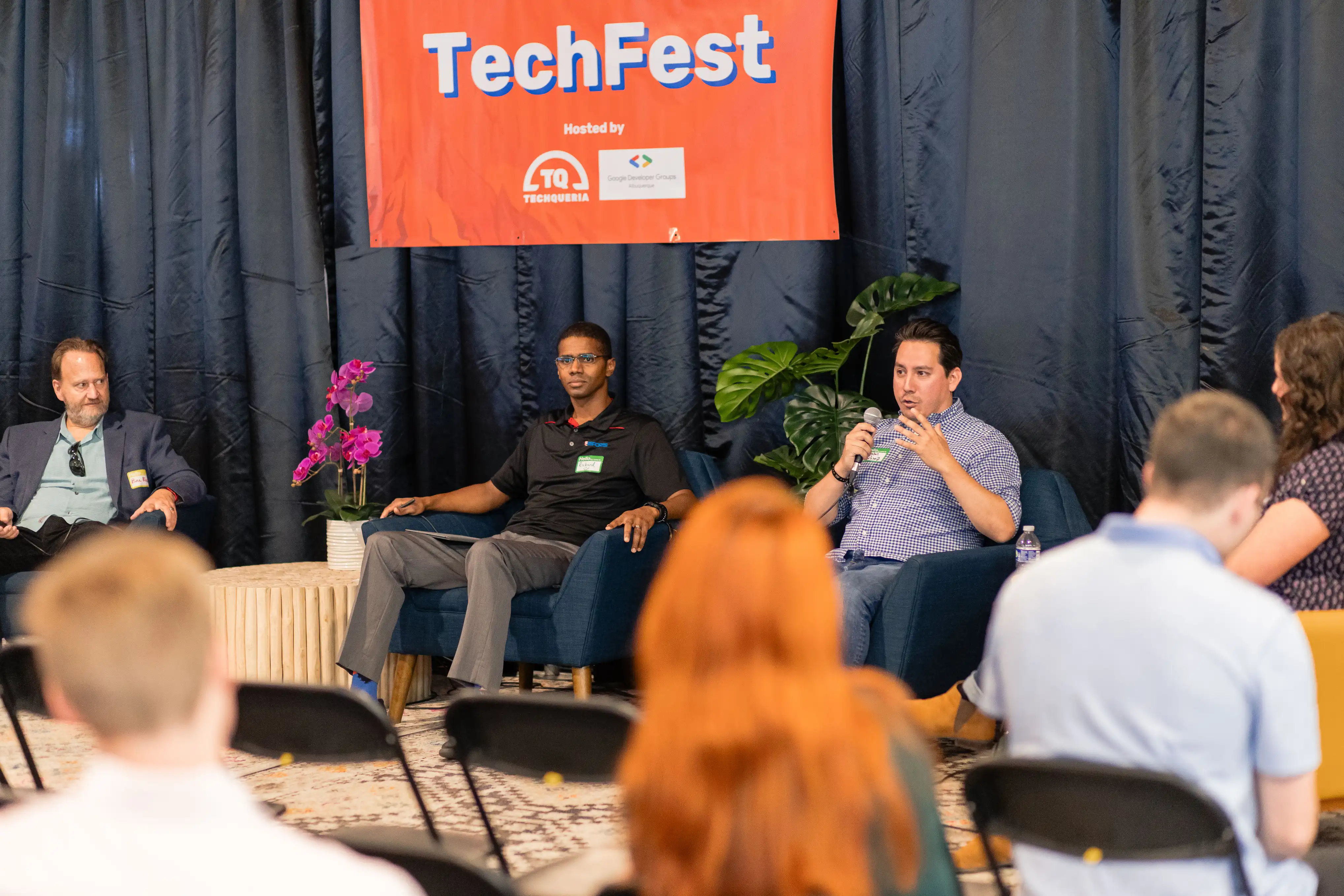 Panel discussion at TechFest 2024 with audience view and TechFest banner
